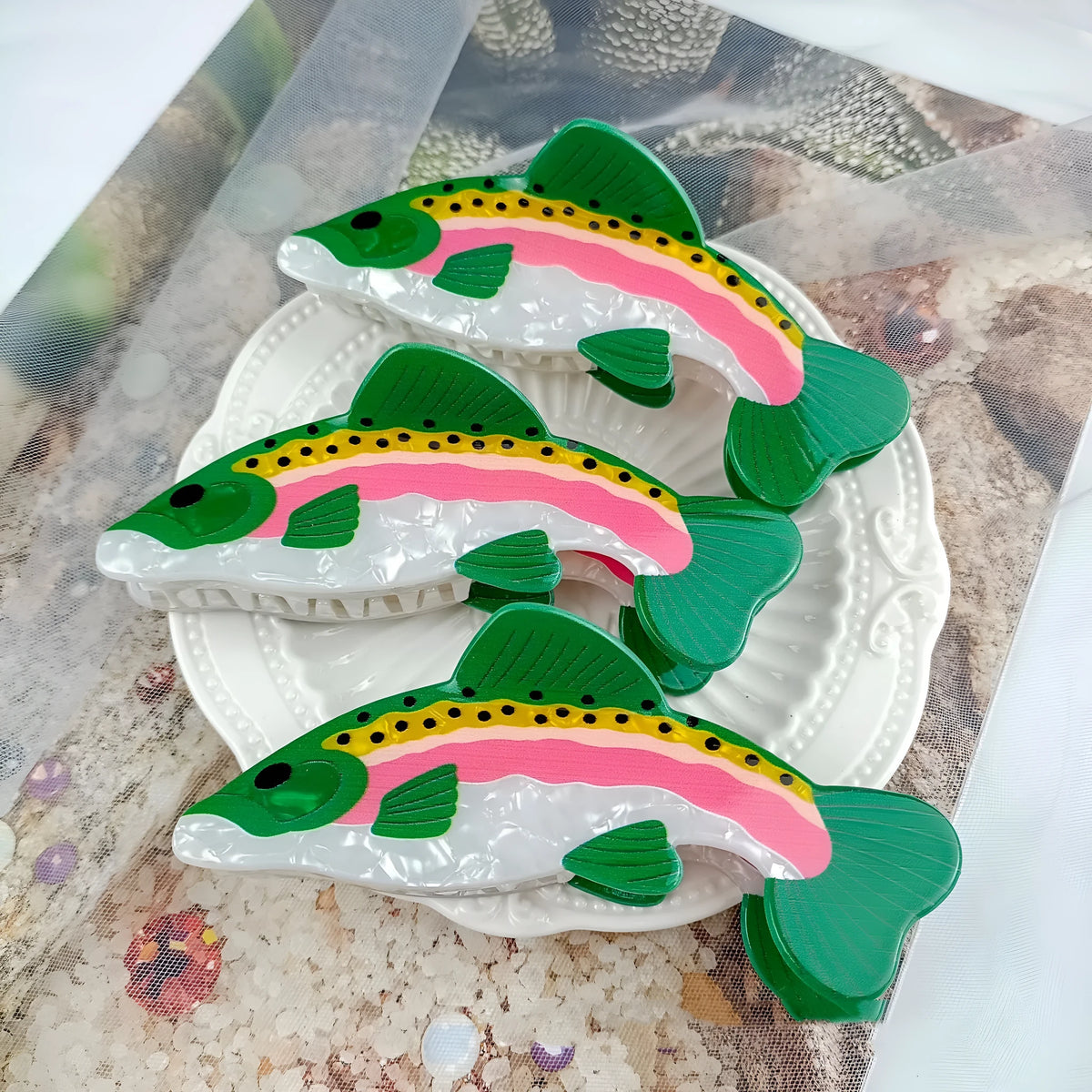 Dark green women's hair clip with detailed printed rainbow trout and carp marine design