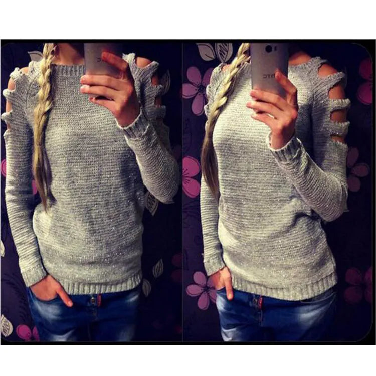 Women's grey hollow-out crocheted knitted long-sleeve shirt with round neck on a hanger.