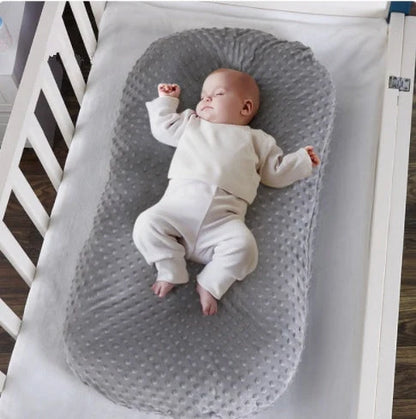 Newborn bionic nap bed in blue and yellow, featuring anti-pressure design and washable fabric