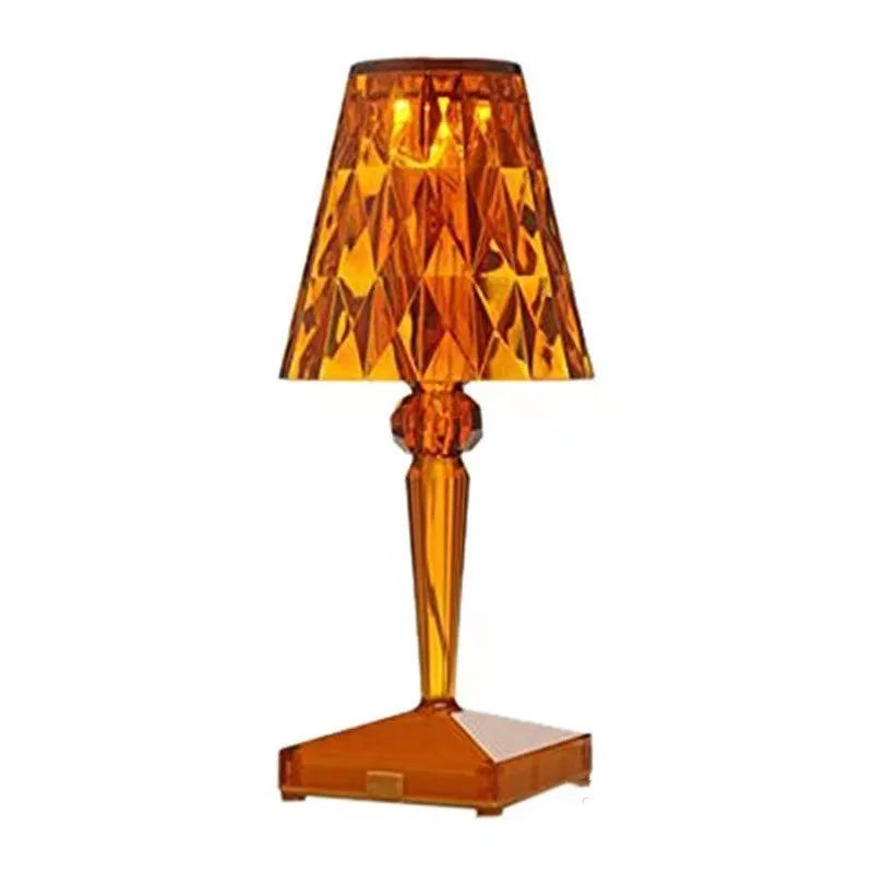 Rose gold portable touch control night light on a surface.