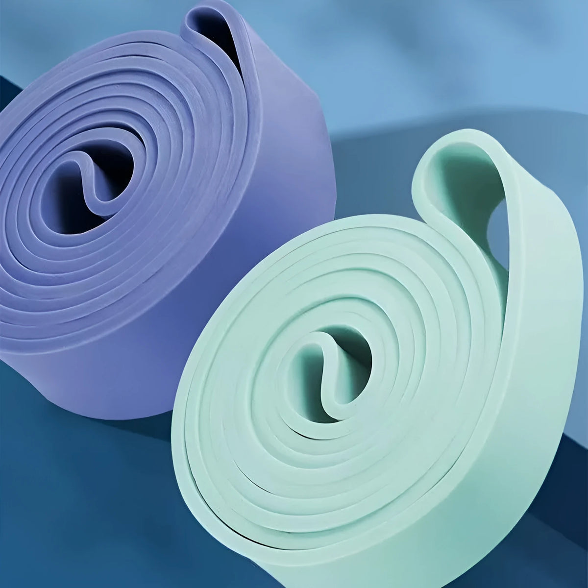 Five TPR resistance bands in Light Blue, Grey, Pink, Fruit Green, and Dark Blue for home exercise