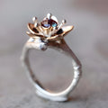 Silver two-tone floral pattern geometric alloy fashion ring for women on a grey background.