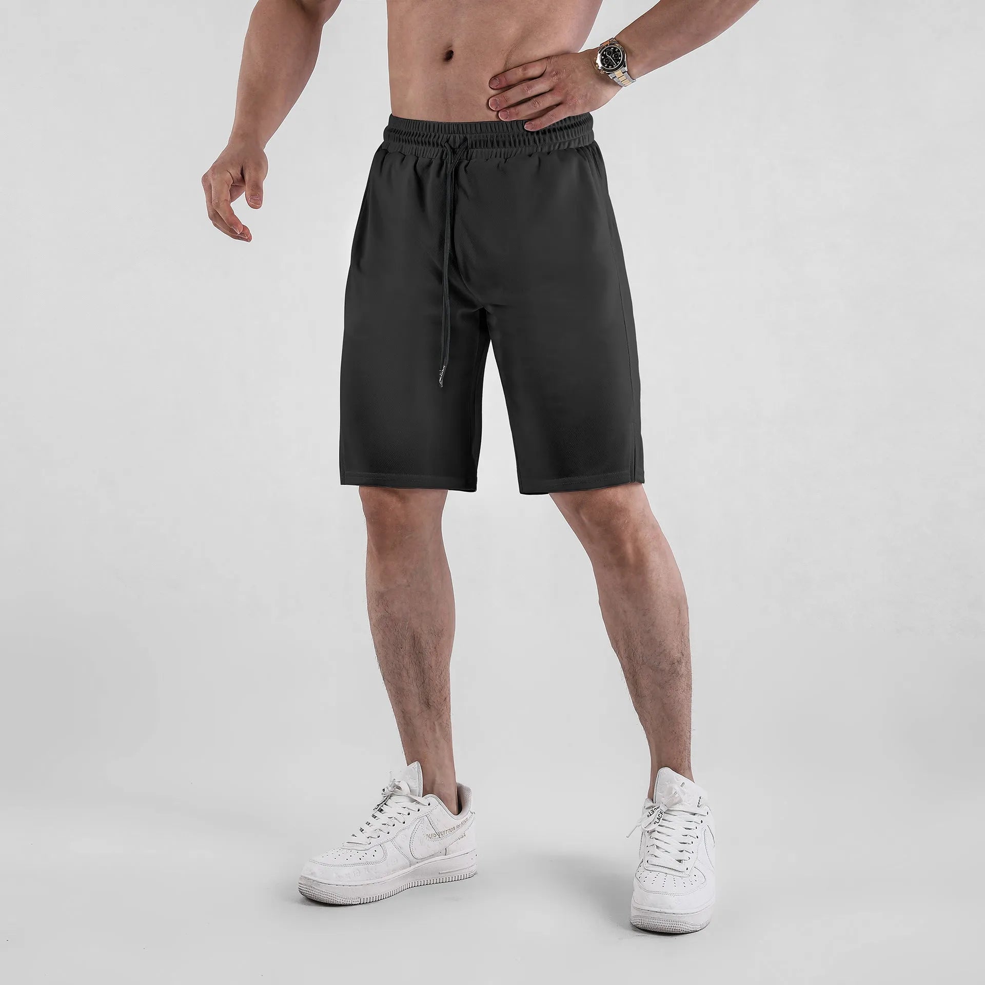 Men's black quick-drying mesh capri shorts with a loose fit and mid waist.