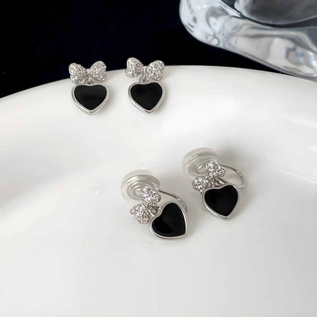 Copper earrings with inlaid zircon heart and bow shapes as a pair of ear clips or ear studs