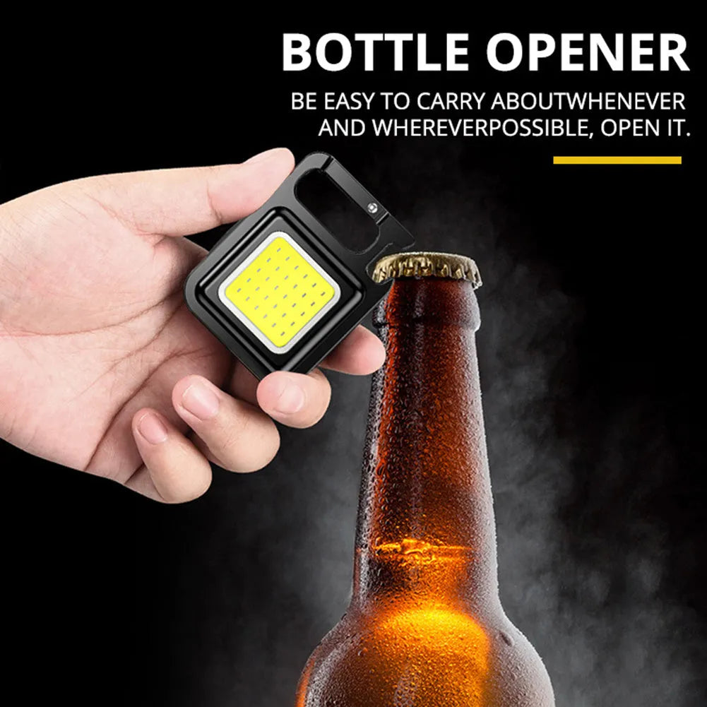 Mini rechargeable COB keychain flashlight with 400 lumens, USB cable, and hook for hands-free use as work light