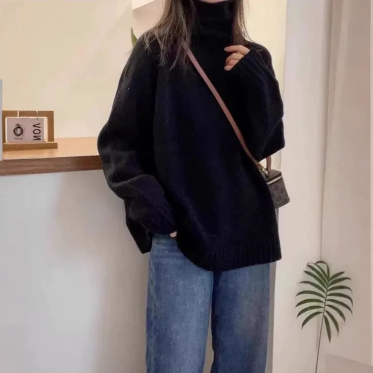 Women's loose thick grey turtleneck sweater with curling pile collar, casual pullover style.