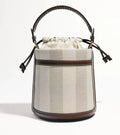 Brown PU cylindrical tote bag with dual handles and woven decorative stitching lines.