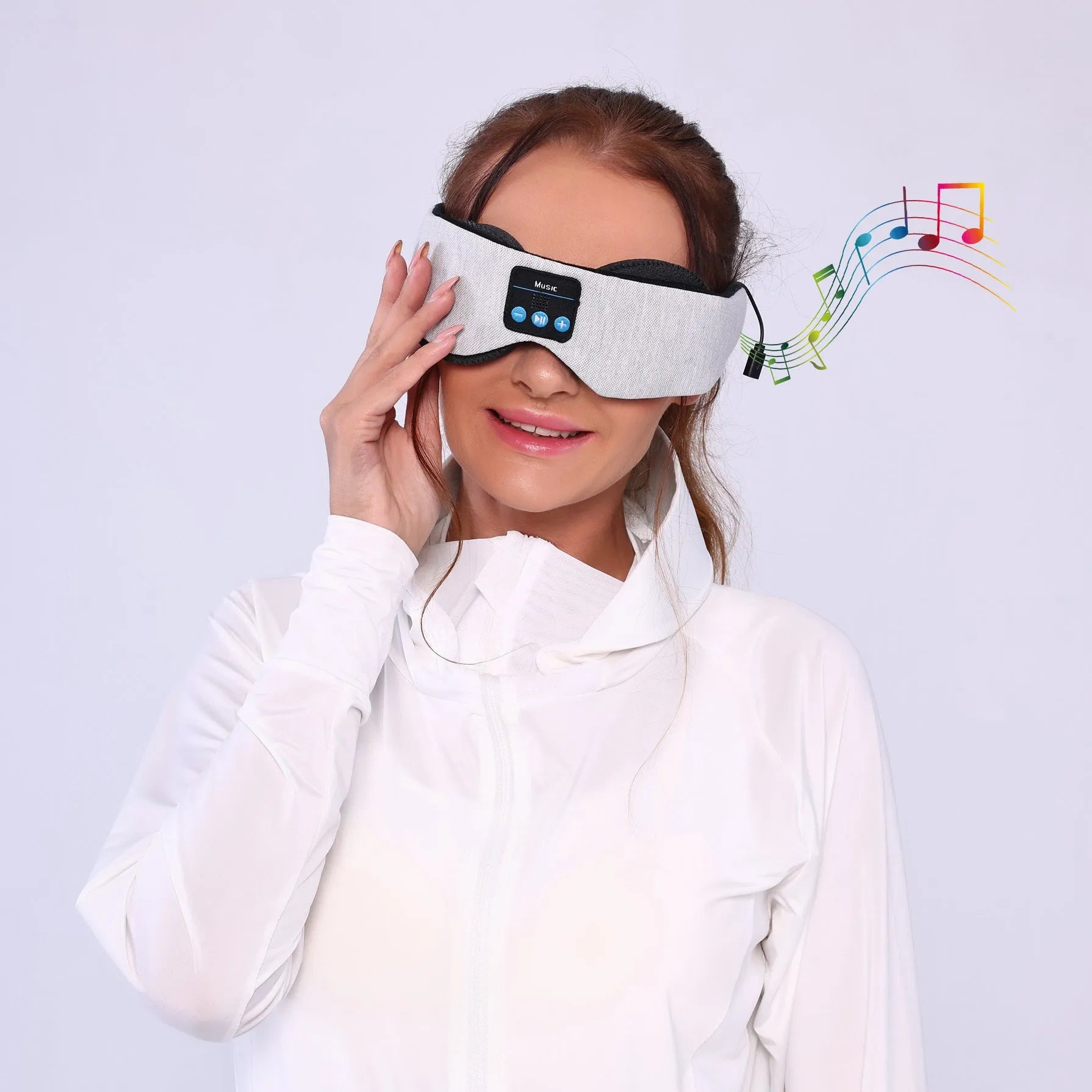 Grey contour Bluetooth sleeping eye mask with built-in speakers for wireless music playback.