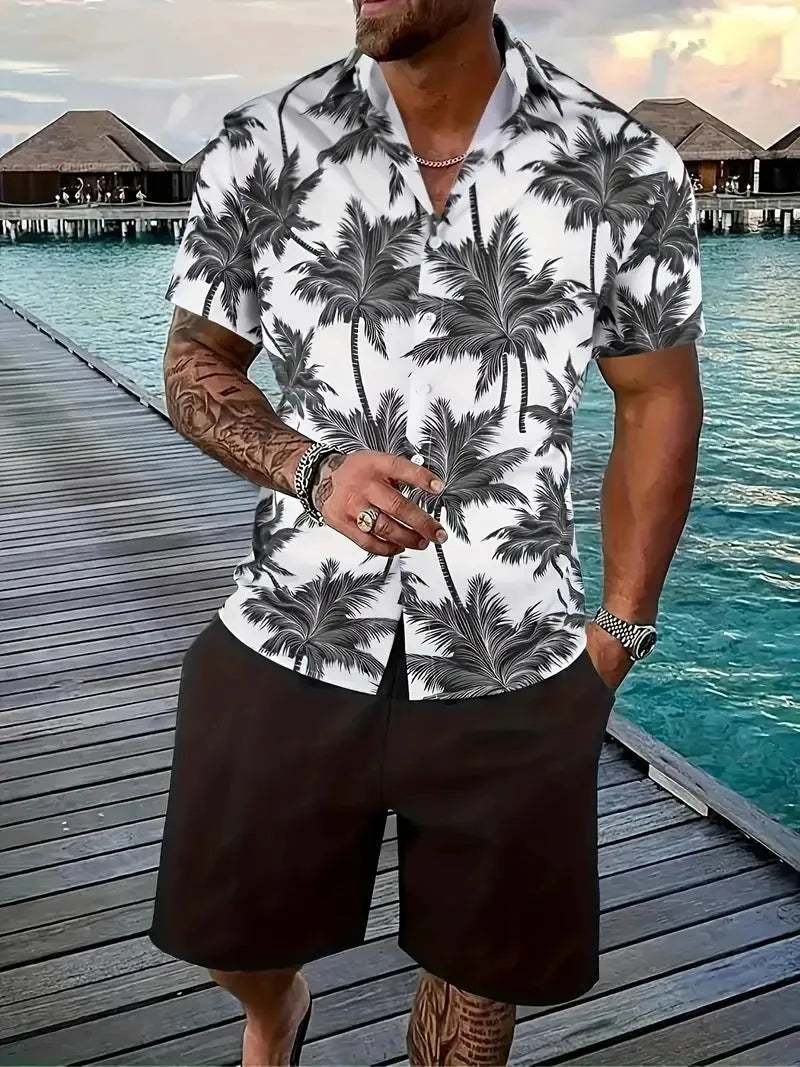 Man wearing a blue Hawaiian print short sleeve shirt and matching shorts from a casual suit set.