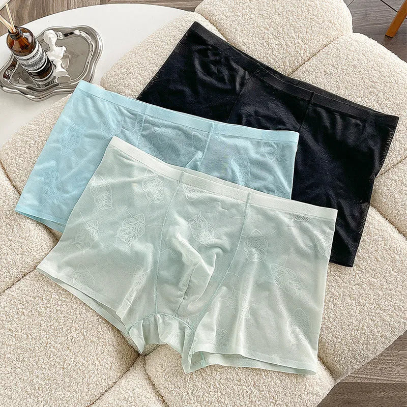 Men's ice silk seamless boxers in mint green – lightweight transparent nylon underwear with mid waist design on white background