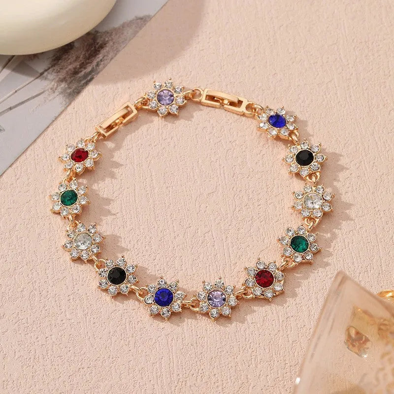 Electroplated zinc alloy bracelet with flower-shaped design and coloured gem elements in metallic finish