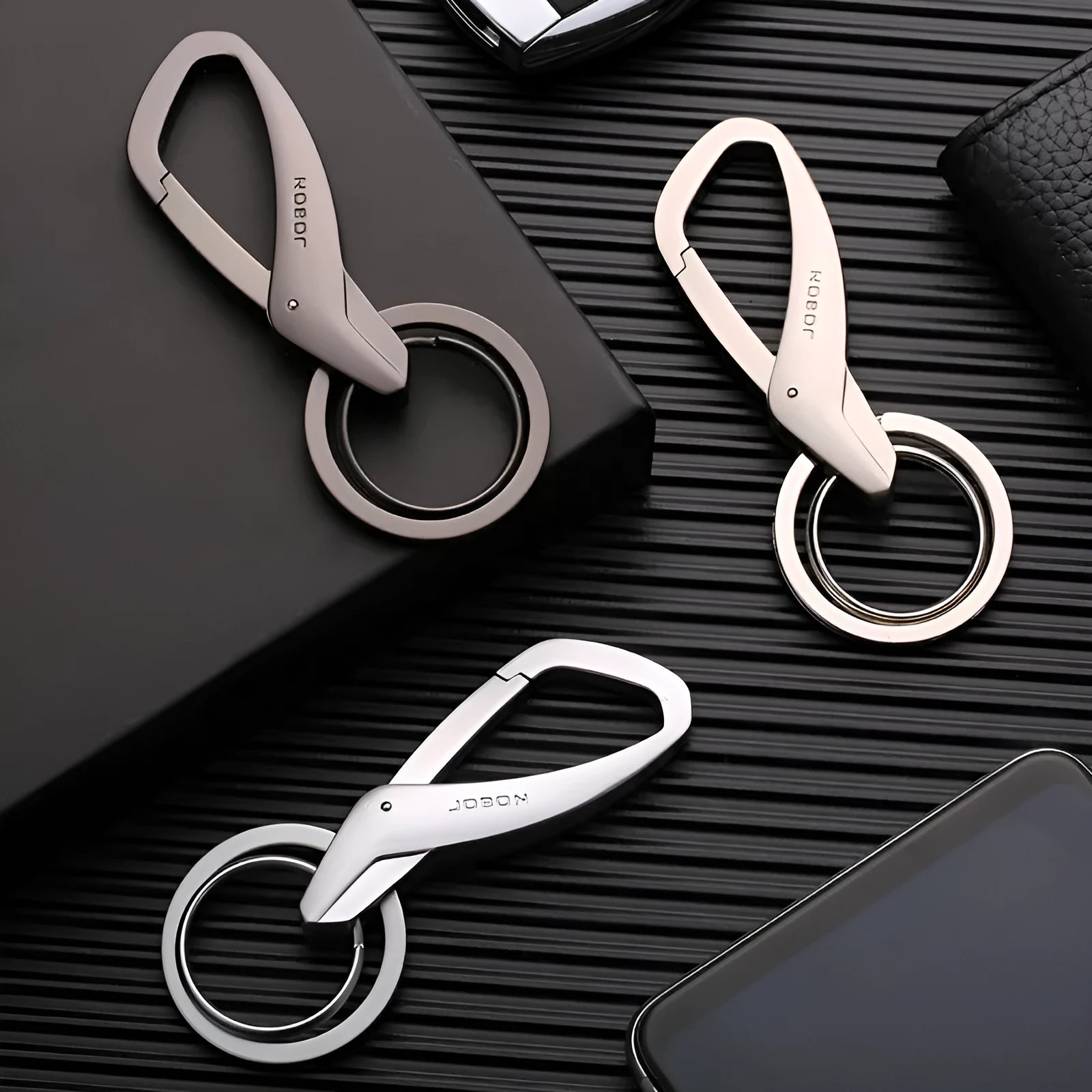 Zinc alloy double ring keychain for car keys in Black, Chrome, or Nickel colour, shown at 8.3x3.5cm size.