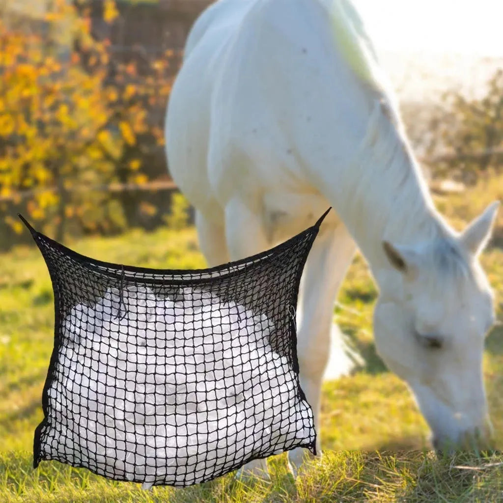 Black woven grid horse feeding bag hanging on a fence