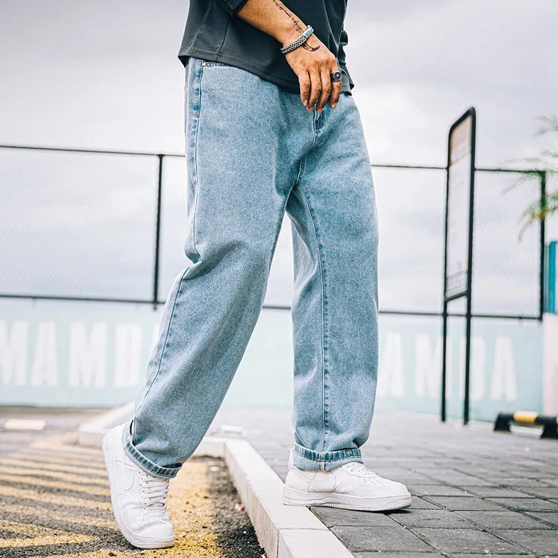 Men's loose straight jeans in dark blue, light blue and grey colours showing simple casual style