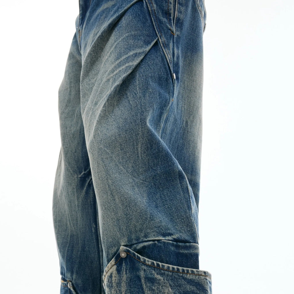 Men's verdant blue loose fit jeans with a washed burst pattern and curved knife leg style.
