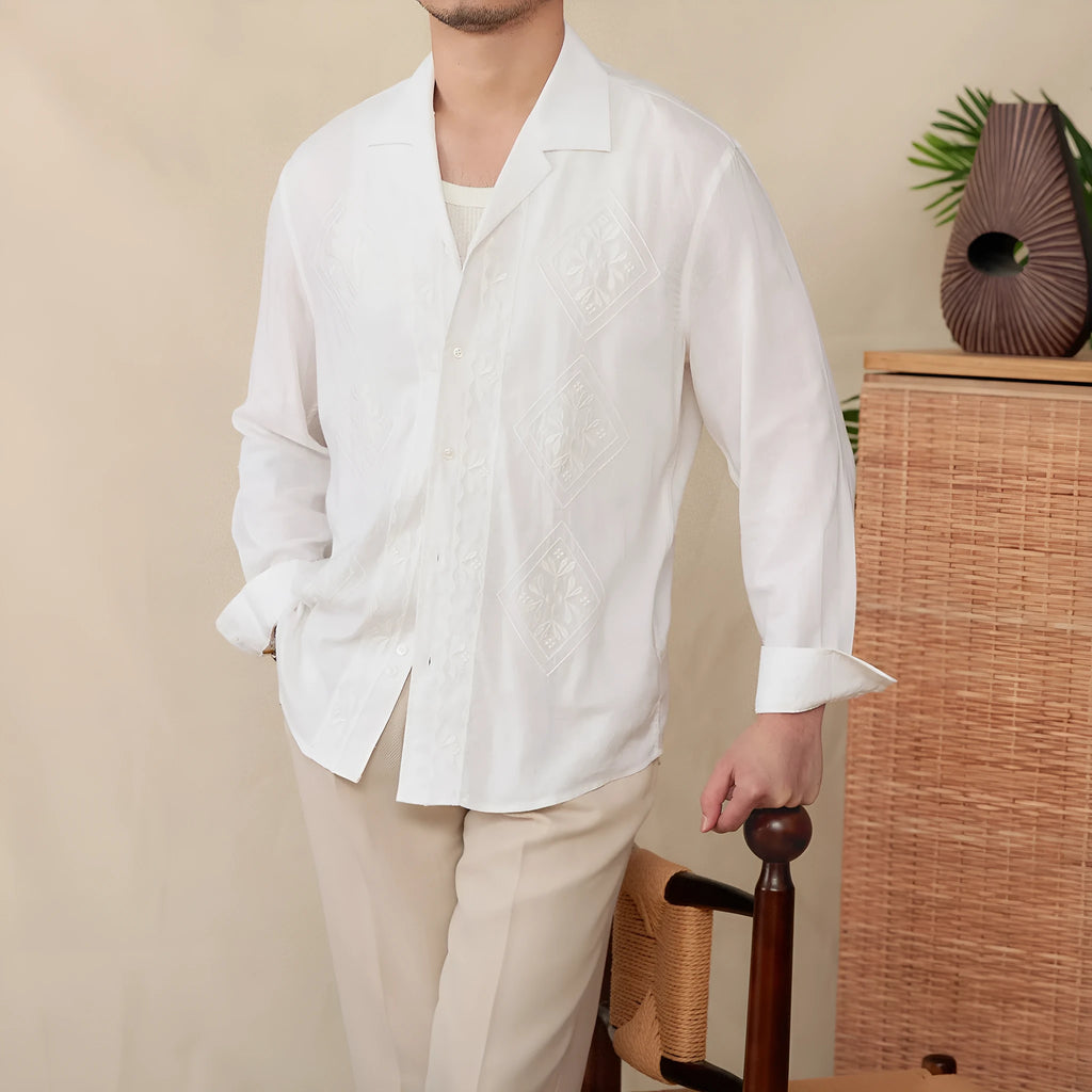 Cotton and linen thin embroidery Cuban collar long sleeve sunscreen shirt in white on a plain background