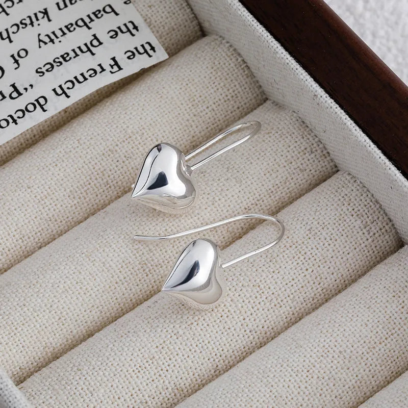 Korean-style silver heart earrings with three-dimensional design and glossy finish