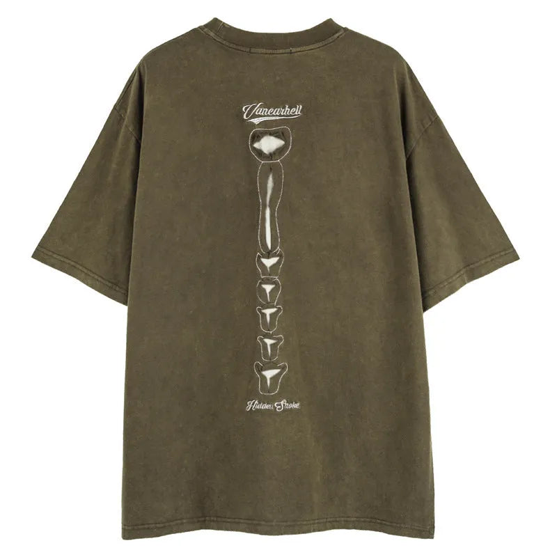 Man wearing a brown loose-fit cotton t-shirt with a large graphic skull print on the front.
