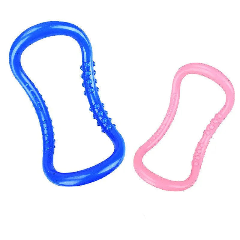 A purple yoga stretching ring made of plastic on a plain background.