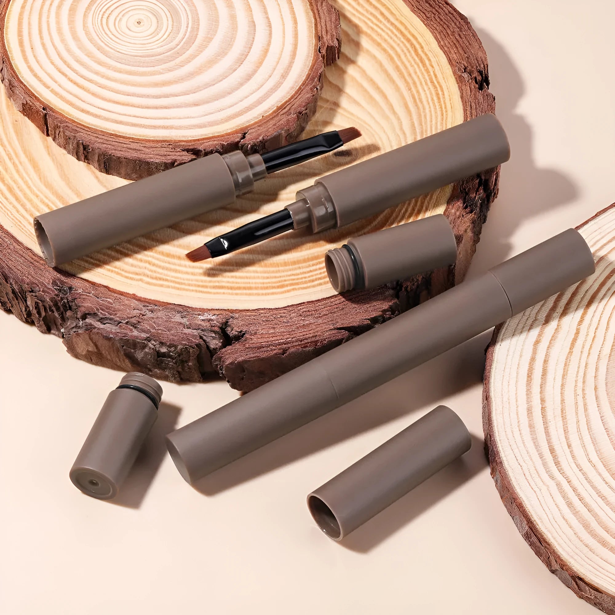Dual-ended eyebrow makeup stick with cream pencil and powder in a case, shown in one of five natural shades.