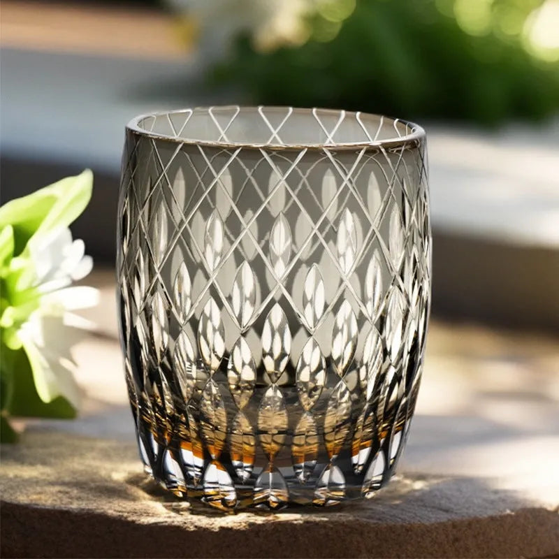 Four Japanese-style Edo crystal glass whisky tumblers in amber and clear cut-glass designs placed in wooden box