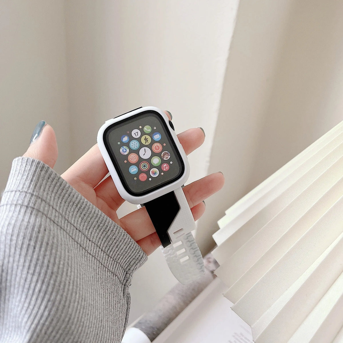 Silicone Apple Watch strap and matching protective case in black and white, two-tone design, for 44mm case size