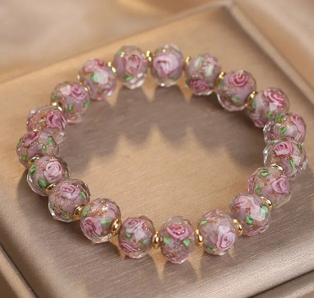 Colour changing artificial crystal bracelet with rose heart design in lake blue finish against a light background