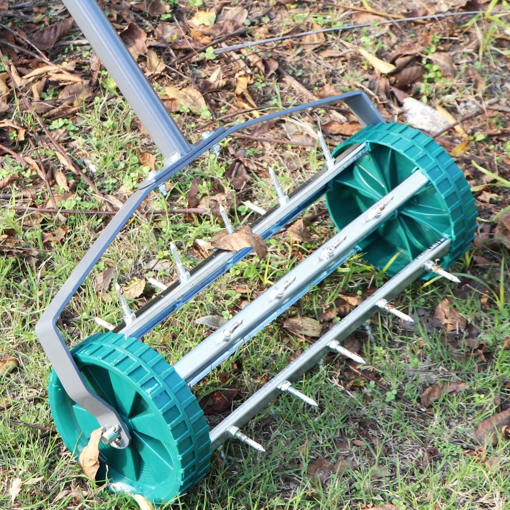 Manual lawn aerator tool with A3 steel construction resting on grass, dimensions 45x24x22cm