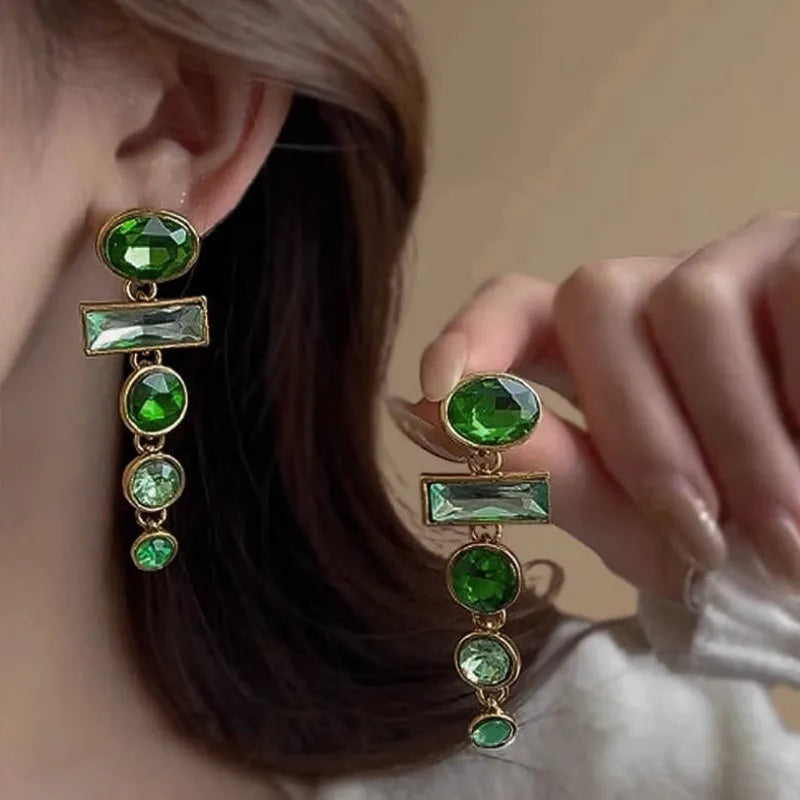 A pair of geometric-shaped green gradient earrings with zircon stones and a tassel, in a Chinese style.