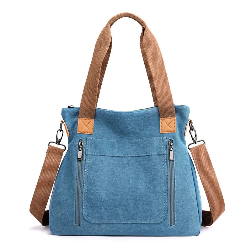 Women's canvas shoulder bag in multiple colours, showcasing spacious interior and zipper closure.