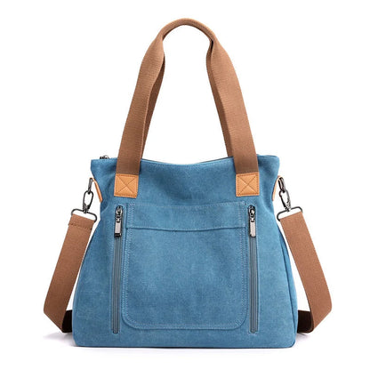 Women's canvas shoulder bag in multiple colours, showcasing spacious interior and zipper closure.