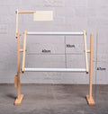 Vertical pine wood cross stitch embroidery frame on desktop with adjustable height mechanism