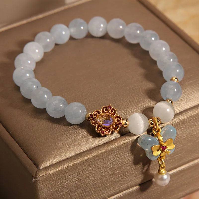 Women's aquamarine butterfly pendant crystal bracelet with rhinestone detailing on wrist