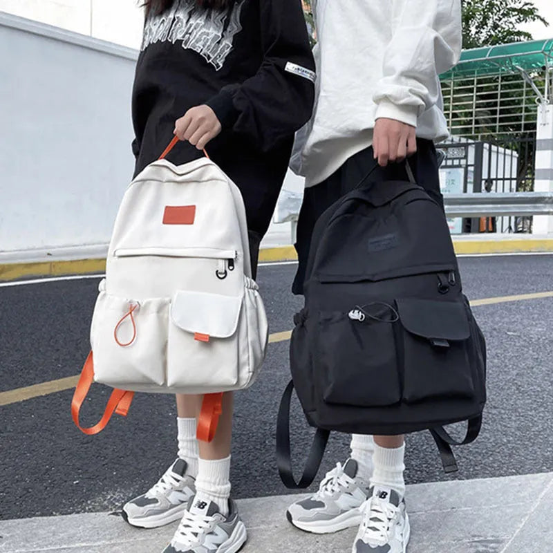 Nylon backpack school bag for junior high students, waterproof, lightweight, available in black, blue, pink, and white colours
