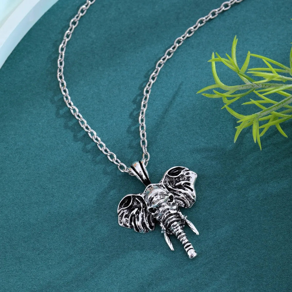 Silver and black elephant god pendant necklace on display, stainless steel construction for men.