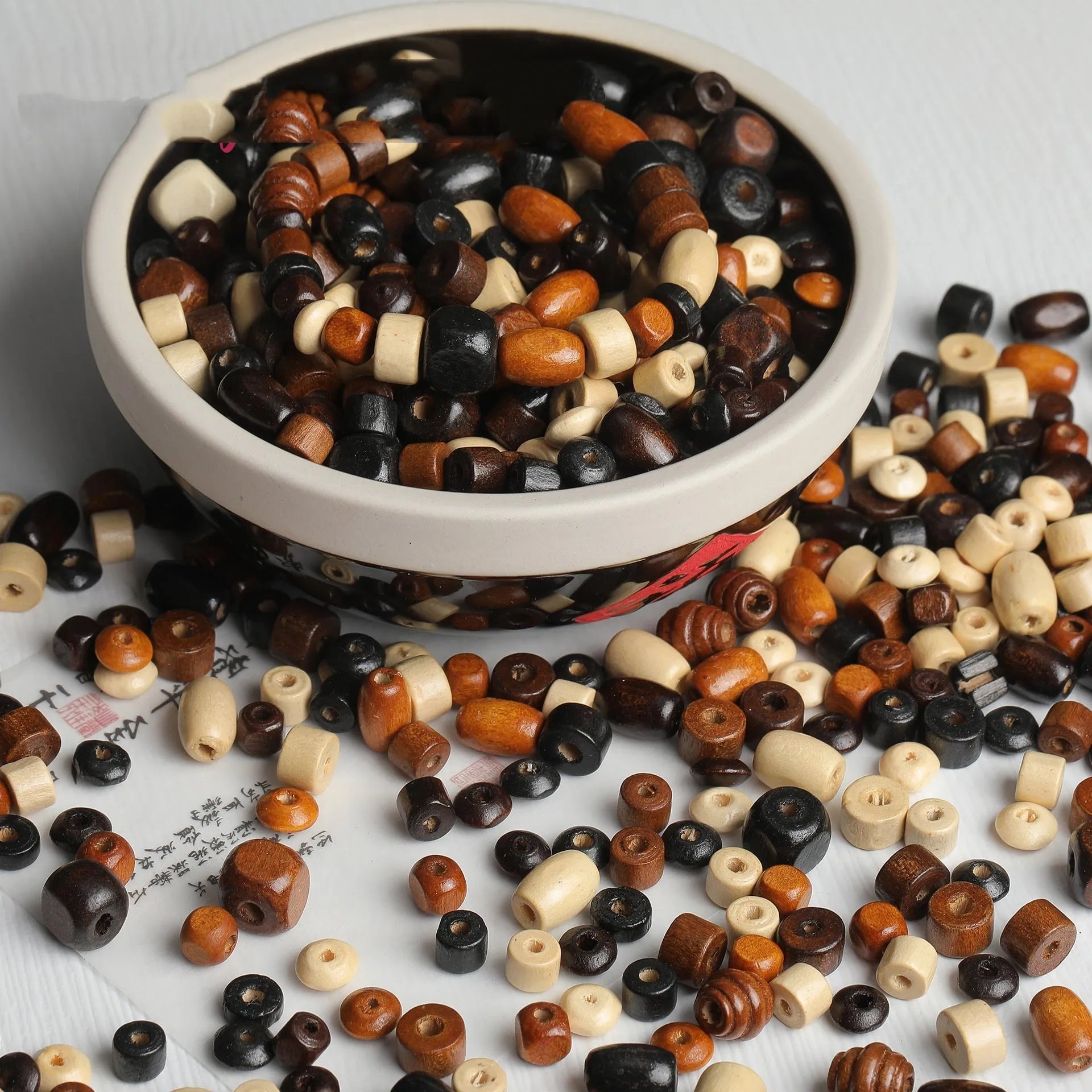 Scattered vintage solid wood beads in mixed colours for DIY jewellery making.