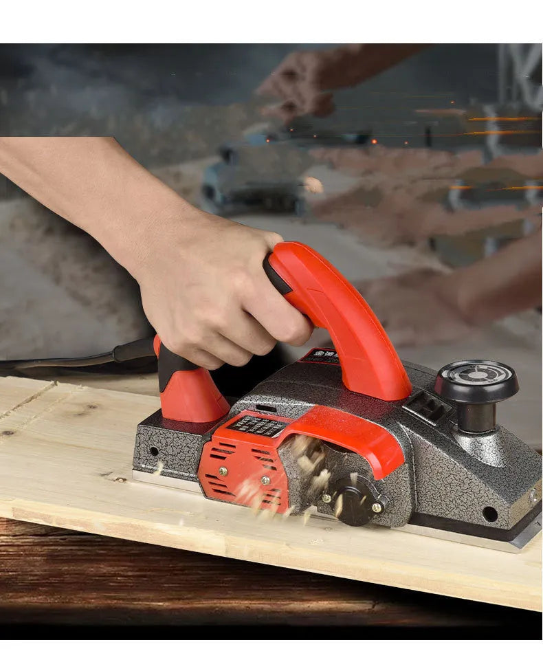 Red desktop electric wood planer with aluminium body showing 82mm planing width and depth adjustment controls