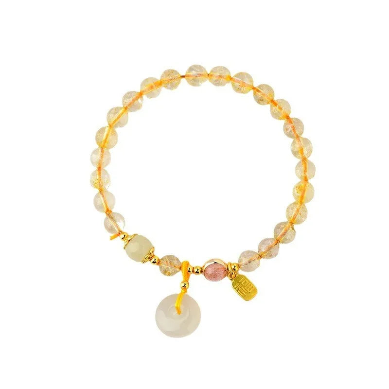 Gold rutilated quartz crystal bracelet with peace buckle closure and blessing card pendant