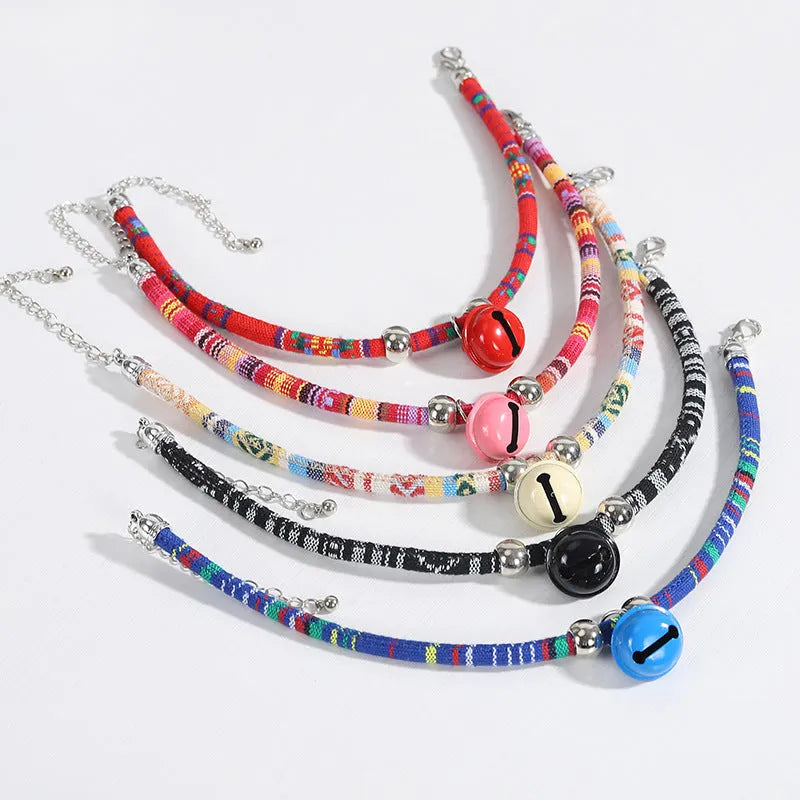 Ethnic pattern adjustable pet collar with bell attachment shown in multiple colour options