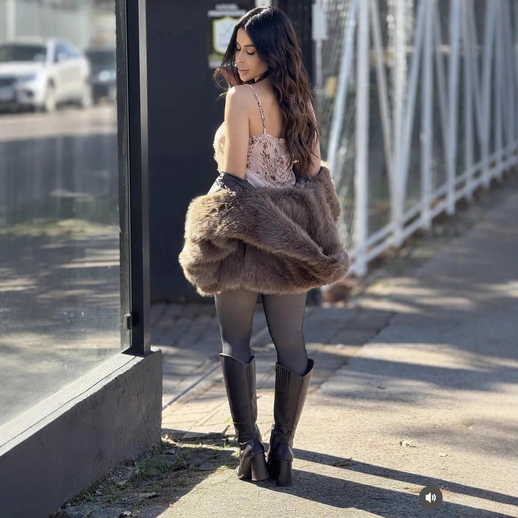 Women's brown loose hooded jacket with fox fur trim on a white background, front view