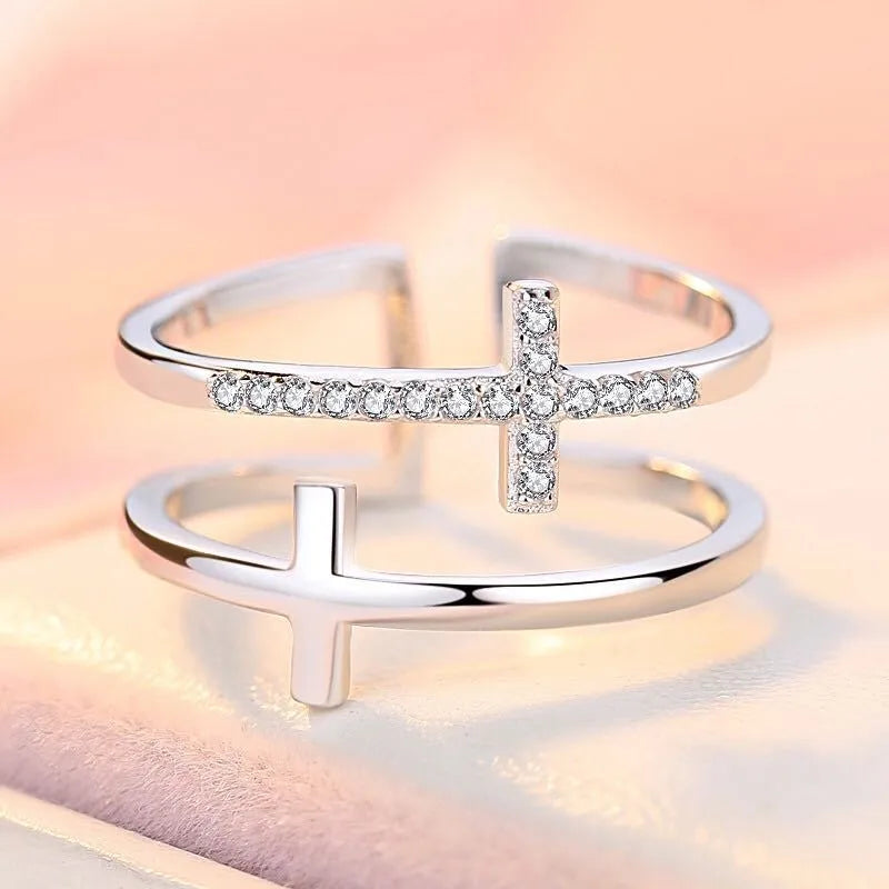Adjustable double cross geometric ring in copper with sterling silver and zircon stone inlay.
