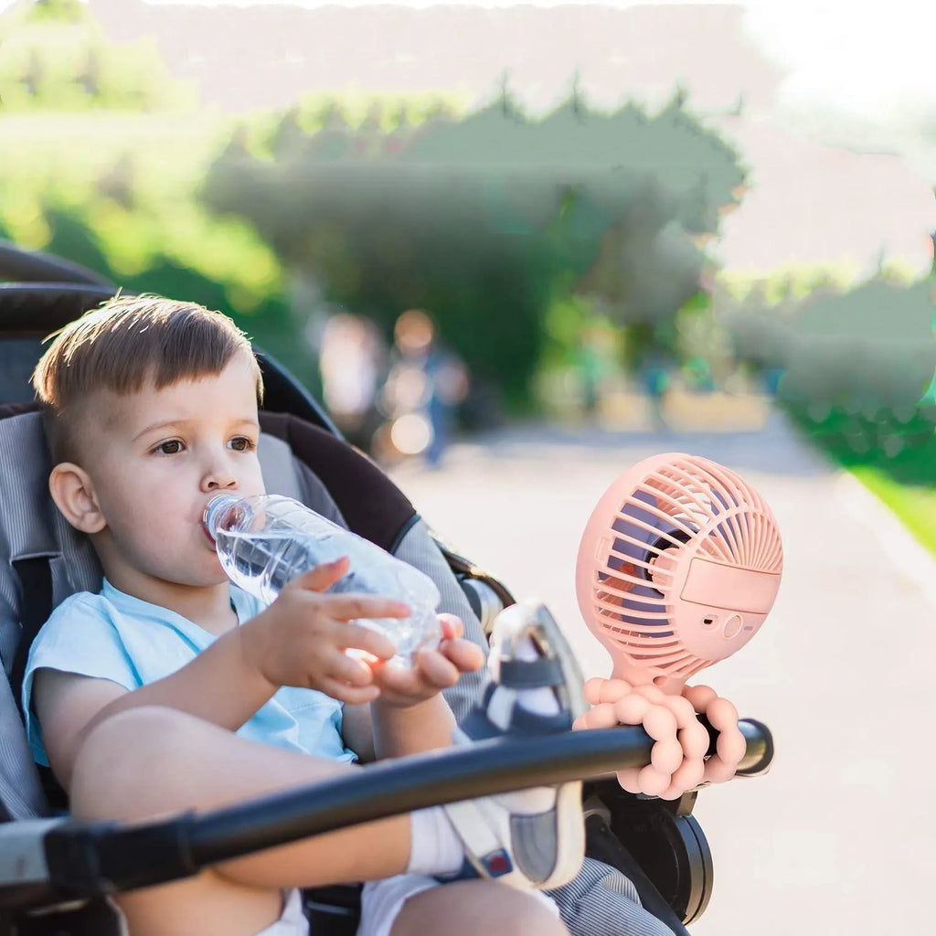 Cute animal design mini stroller fan with LED night light and flexible clip in pink on a stroller