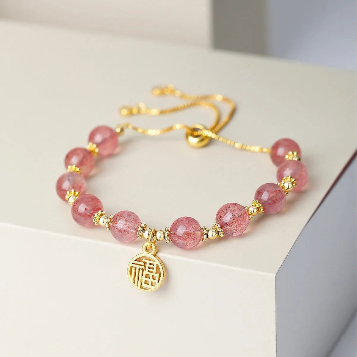 Strawberry quartz electroplated crystal bracelet with geometric fu charm