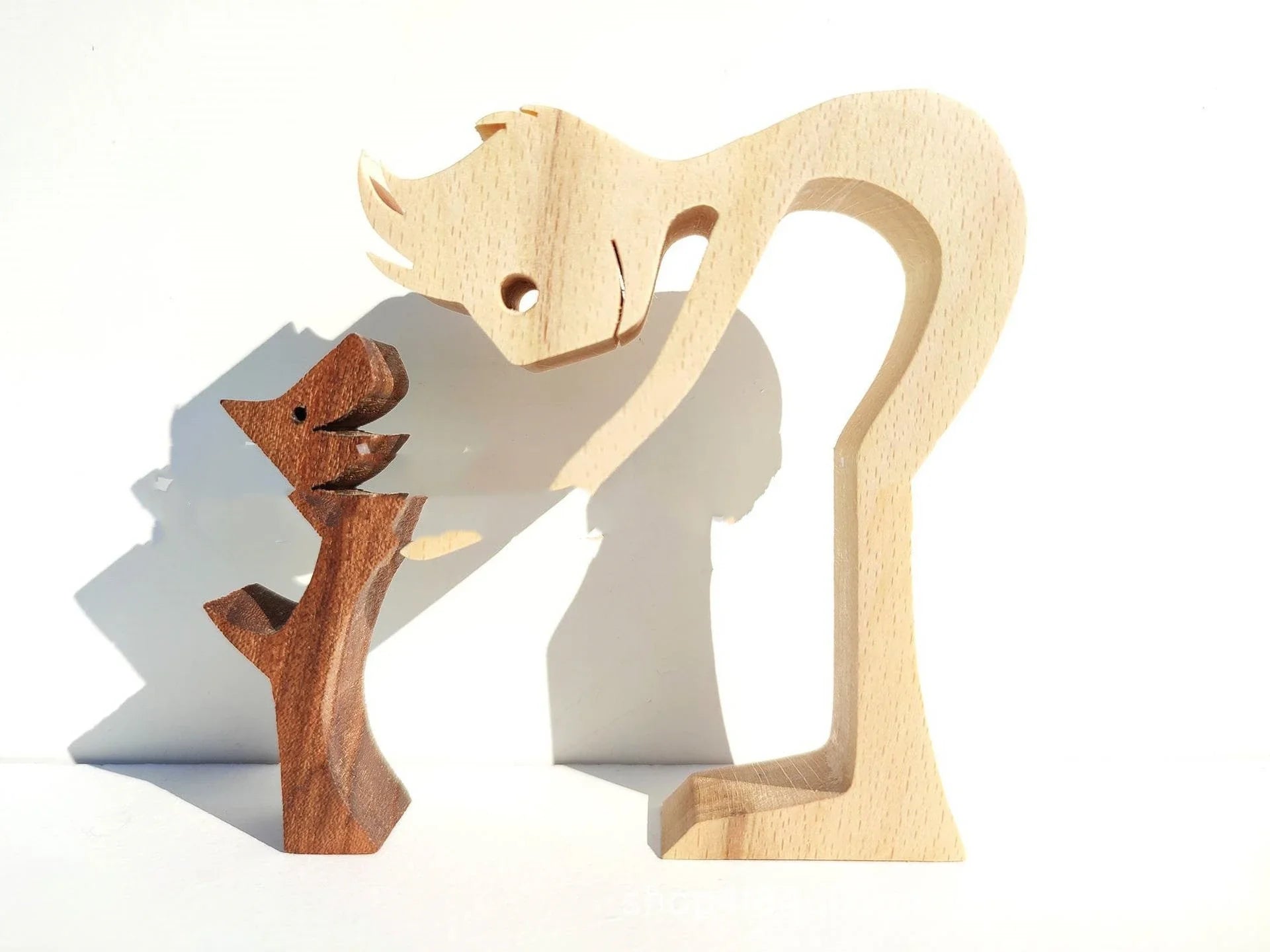 Handcrafted wooden dog sculpture featuring a man and his loyal canine companion