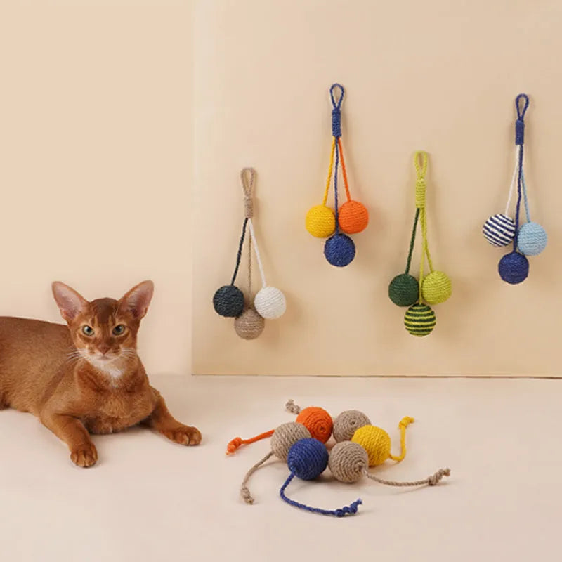 Bite-resistant cat teaser wand set with colourful attachments and catnip ball on a blue background