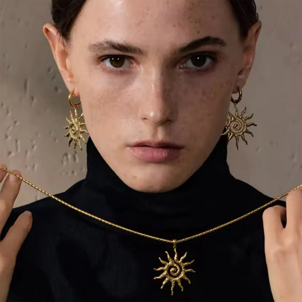 Gold sun hollow pendant necklace and earrings set with electroplated finish on zinc alloy