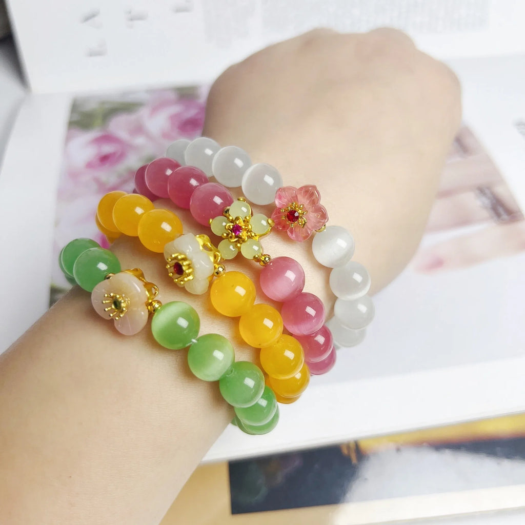 Handmade glass beaded bracelet with floral design in yellow, pink, white, or green colour options.
