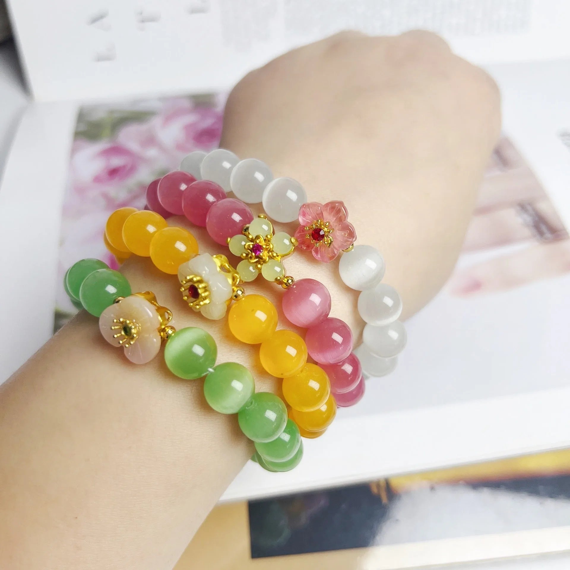 Handmade glass beaded bracelet with floral design in yellow, pink, white, or green colour options.