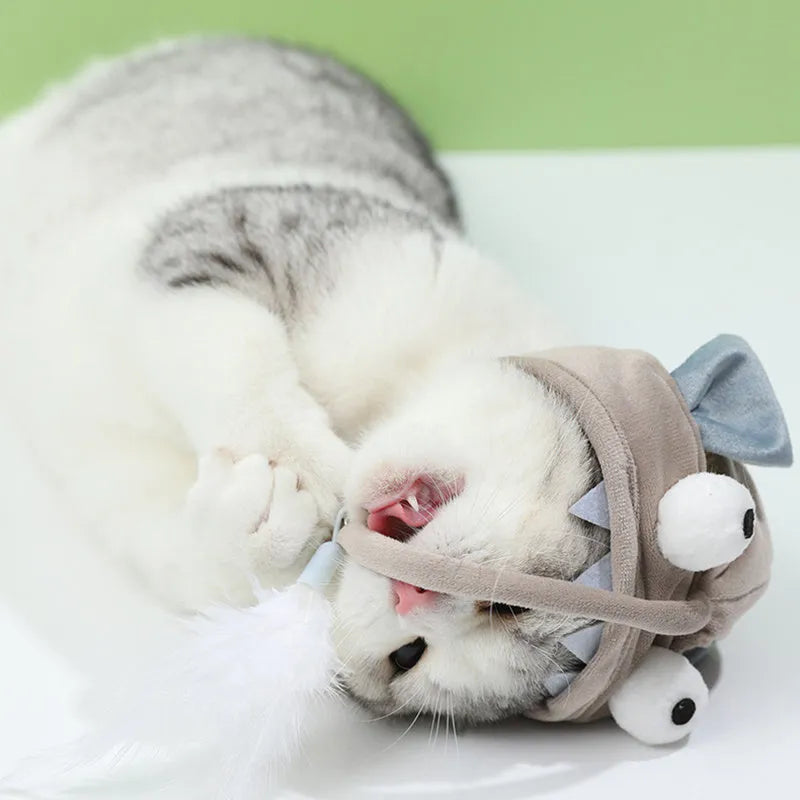 Grey feather head teaser cat stick toy with big eyes, adjustable neckband, shown on a cat.