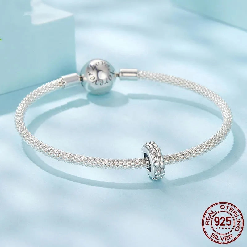 Four-leaf clover shaped S925 sterling silver spacer bead with pearlescent finish, 1.0cm height